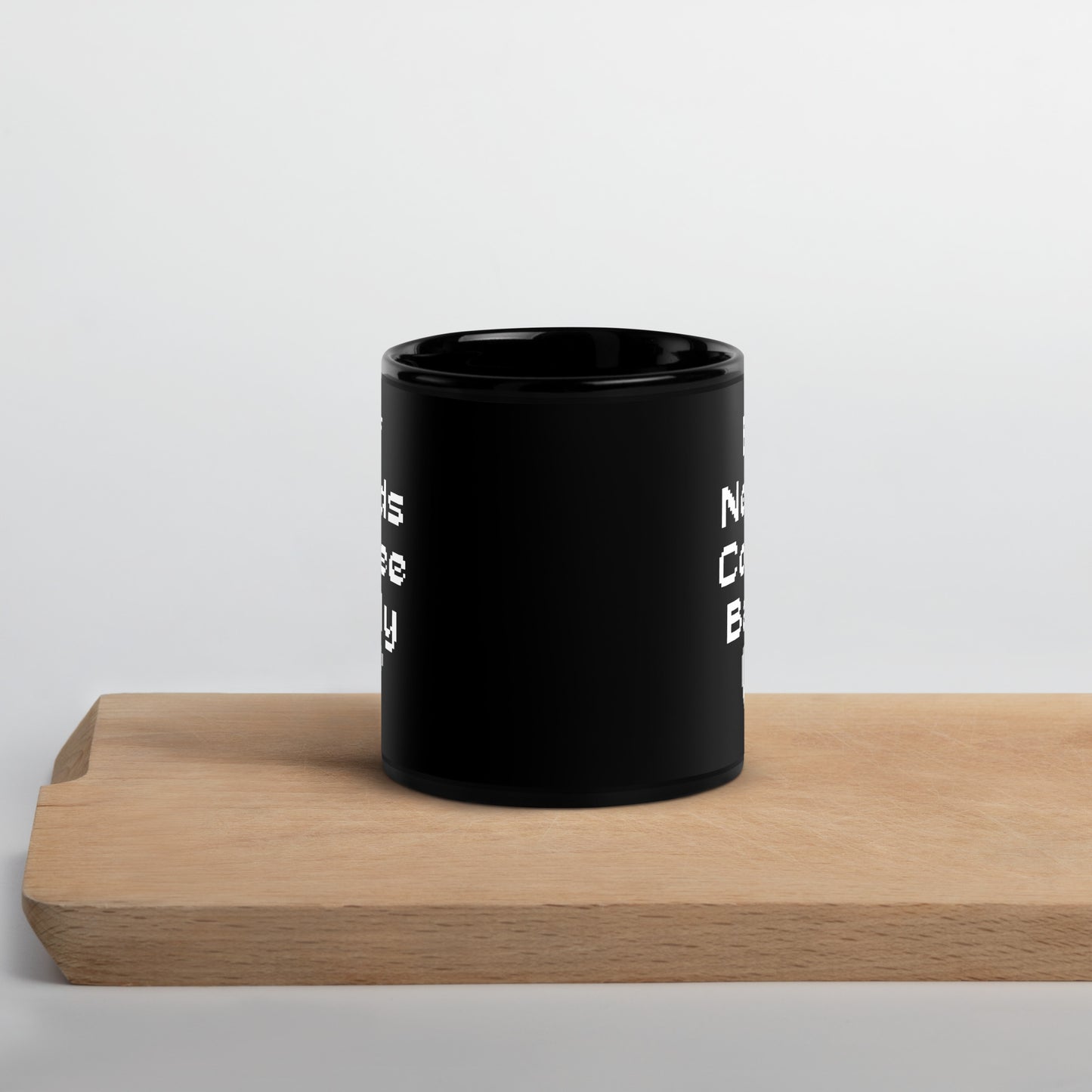 Black 11oz retro coffee mug featuring an ‘Elf Needs Coffee Badly’ video game design sitting on cutting board.