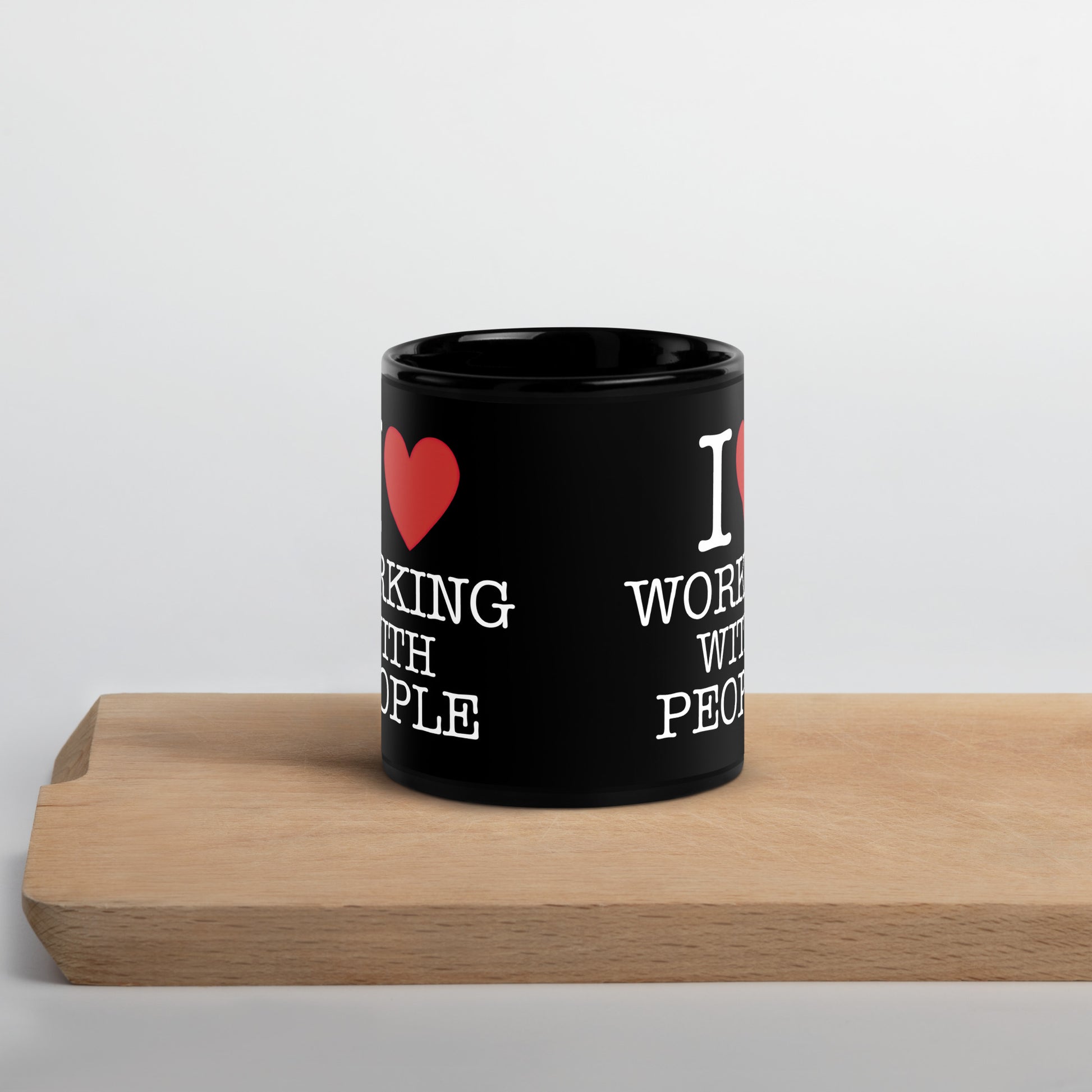 Black 11oz tech humor coffee mug with an I Love NY style design that reads ‘I Love Working With People’.