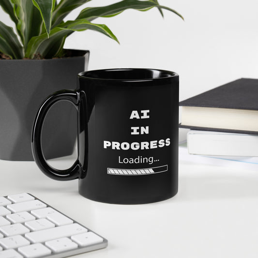 Black 11oz tech humor and AI coffee mug featuring slogan “AI in Progress” with handle on the left.