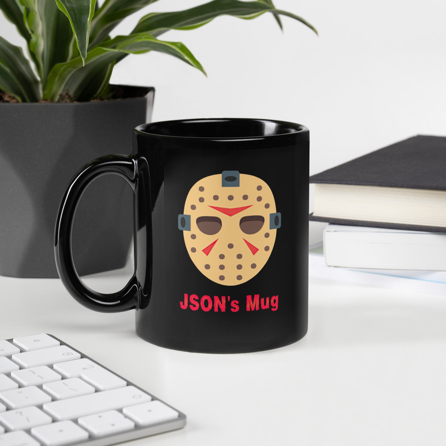 Black 11oz tech humor horror coffee mug with a hockey mask design that reads ‘JSON's Mug’ handle on the left.