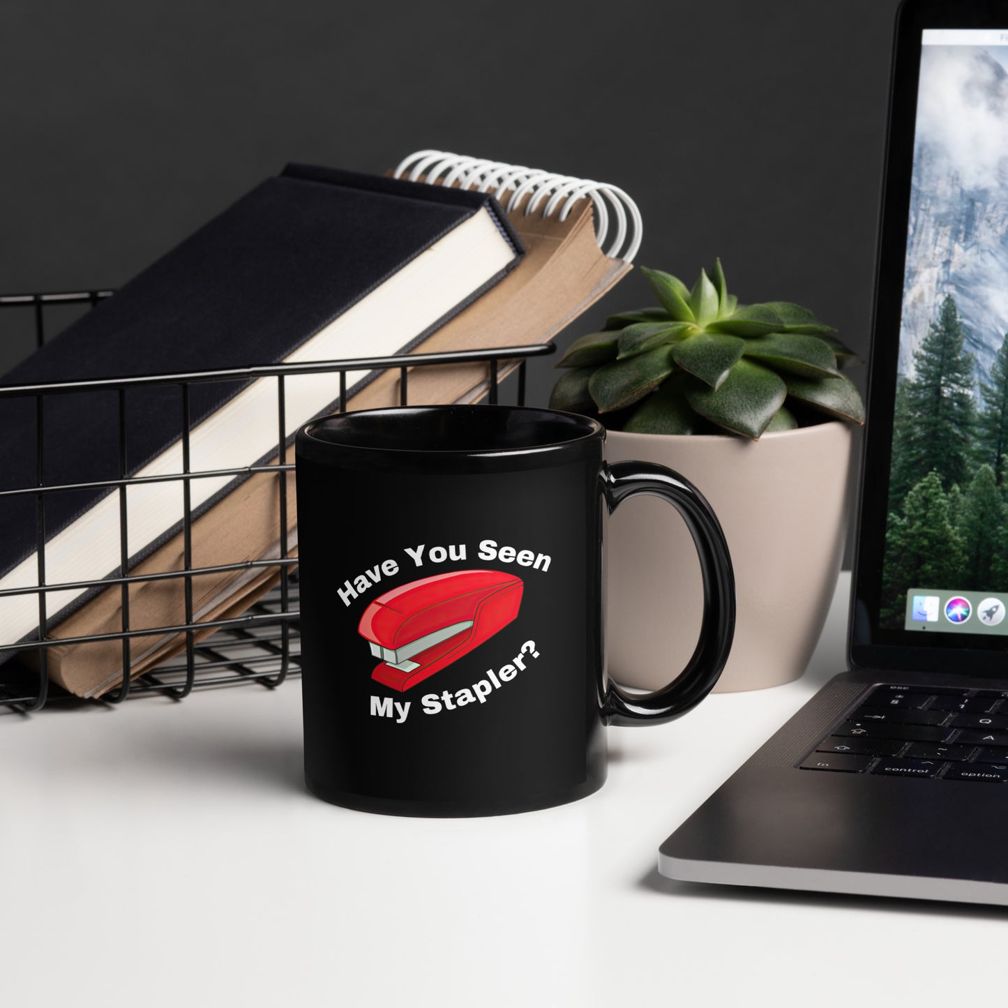 Black 11oz retro tech humor coffee mug with a stapler image and slogan ‘Have you seen my stapler?’ with handle on right.