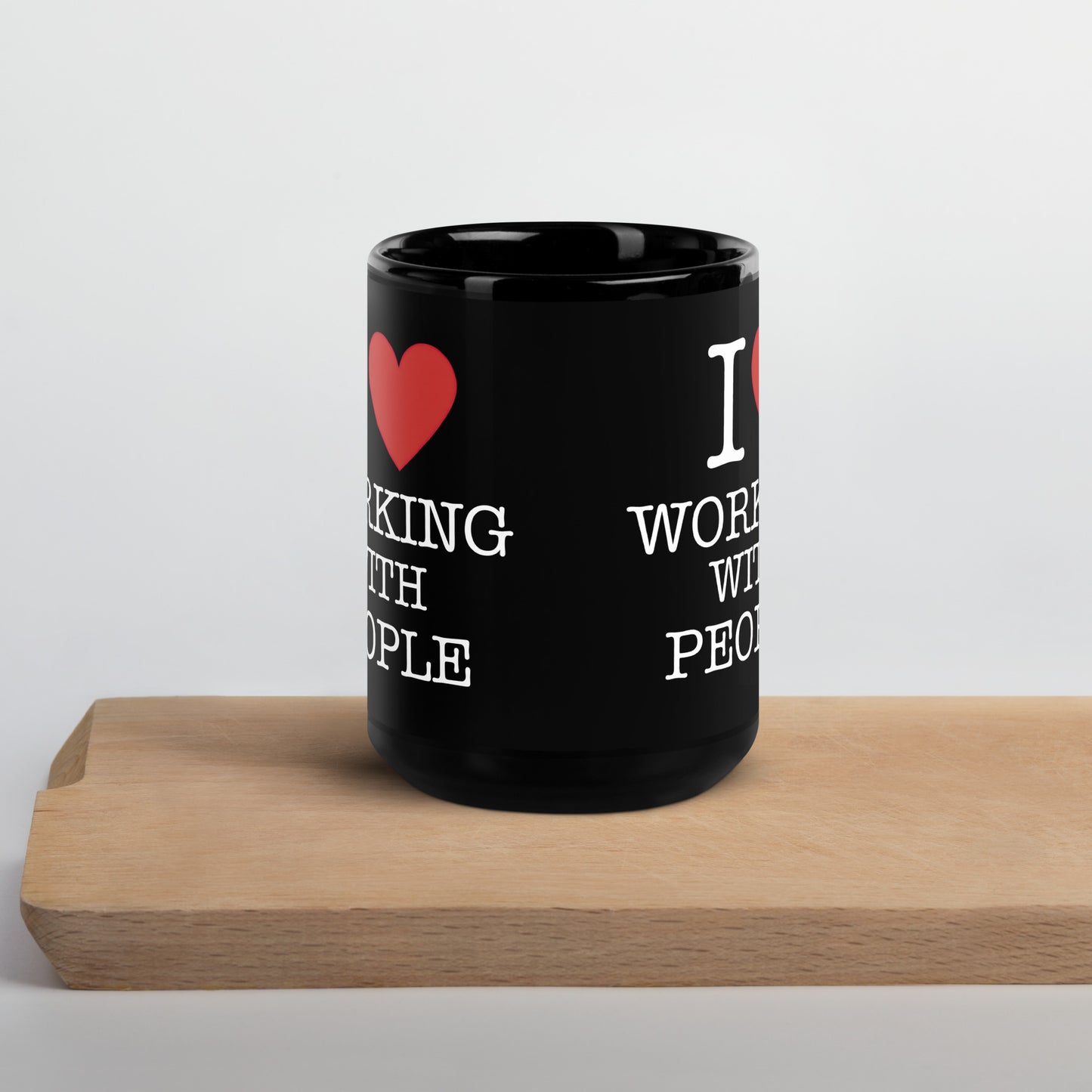 Black 15oz tech humor coffee mug with an I Love NY style design that reads ‘I Love Working With People’.