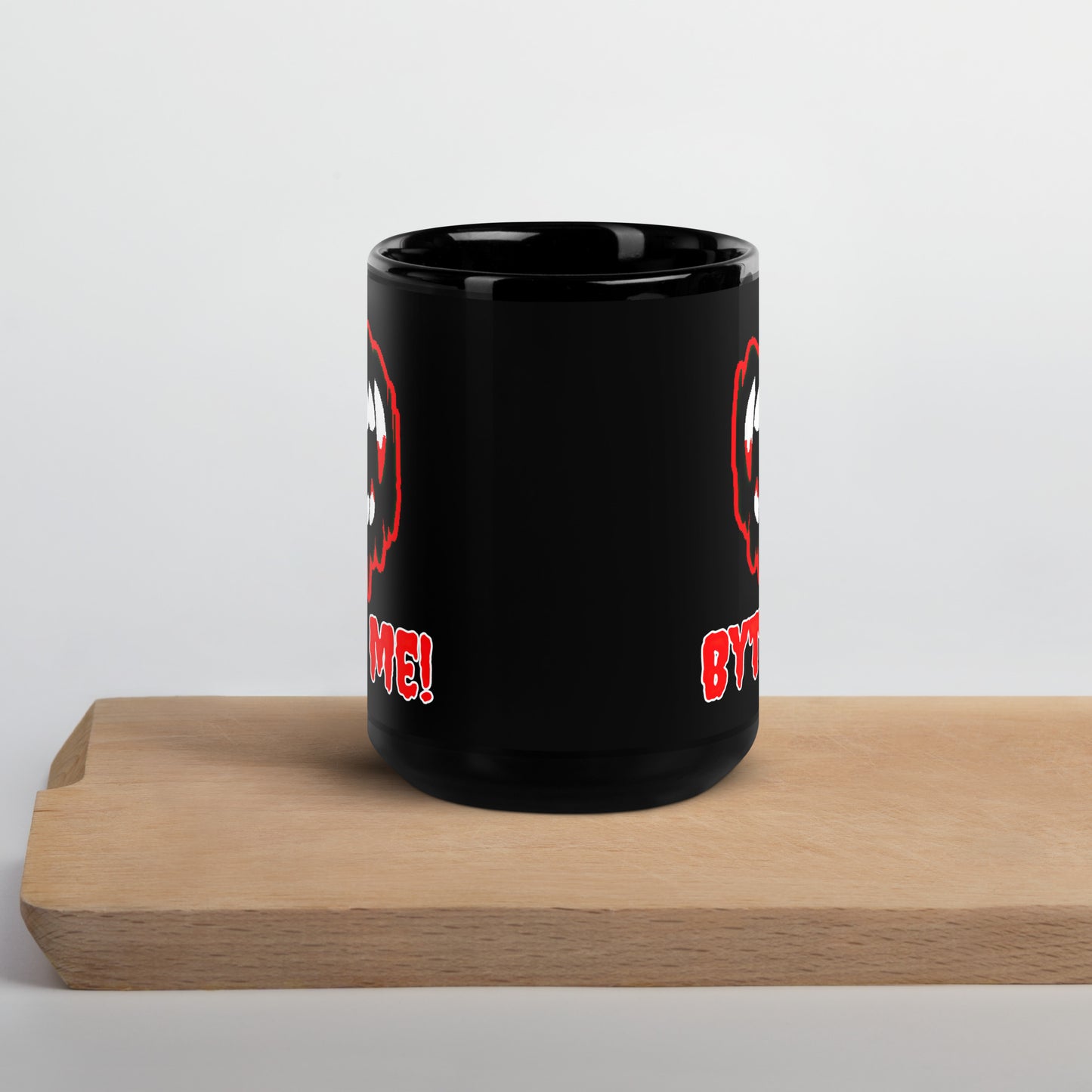 Black 15oz tech humor Halloween coffee mug featuring slogan “Byte Me!” under pixelated vampire fangs.