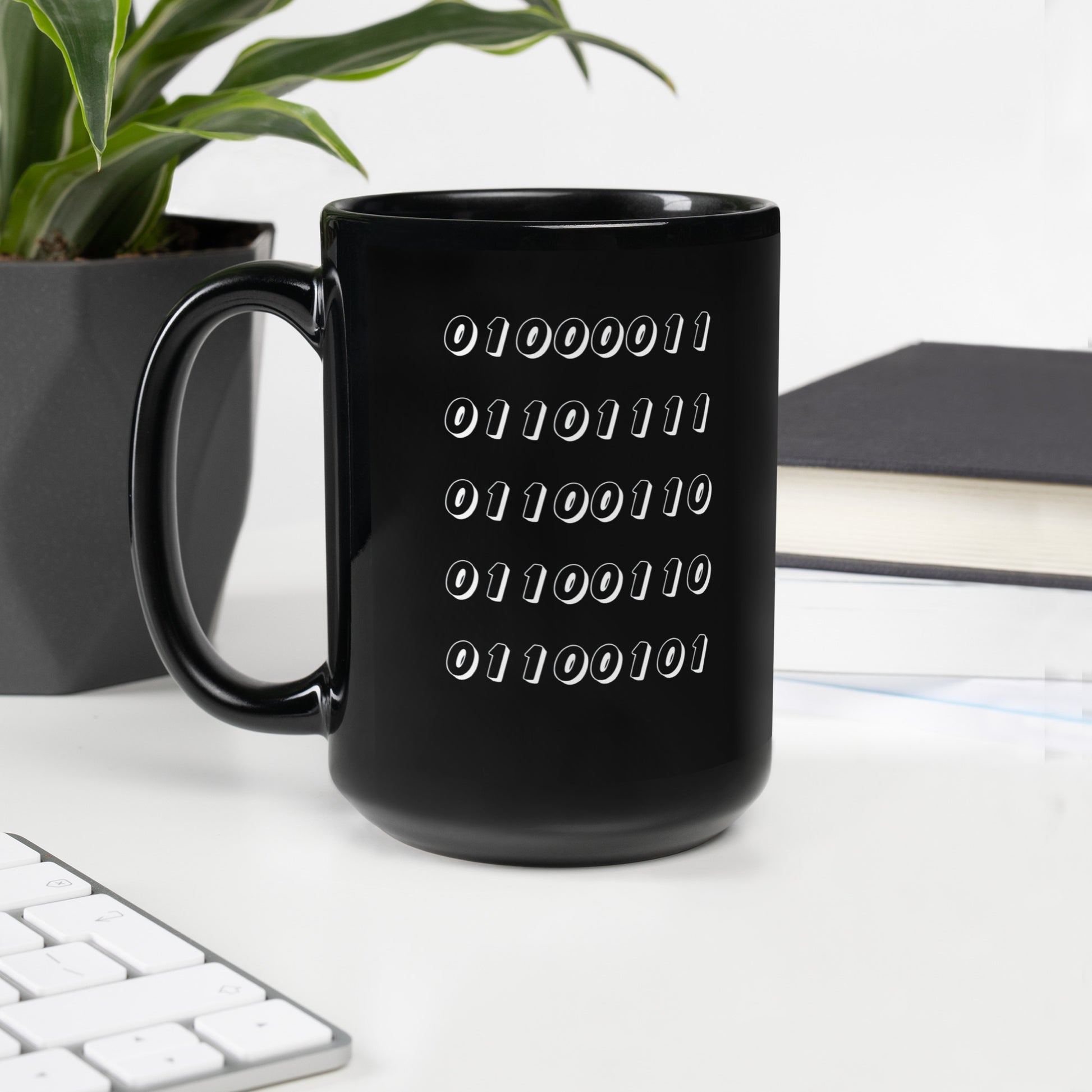 Black 15oz tech humor coffee mug featuring the word “Coffee” written in binary with handle on the left.