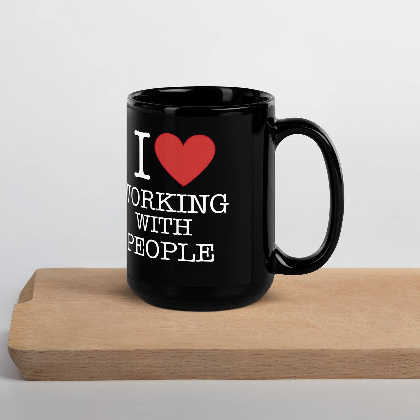 Black 11oz tech humor coffee mug with an I Love NY style design that reads ‘I Love Working With People’ with handle on right