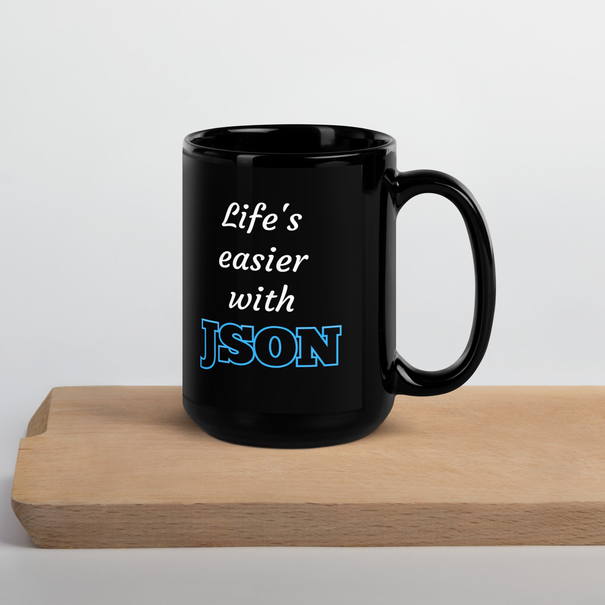 Black 15oz tech humor coffee mug with design that reads ‘Life's easier with JSON’ with handle on the right.