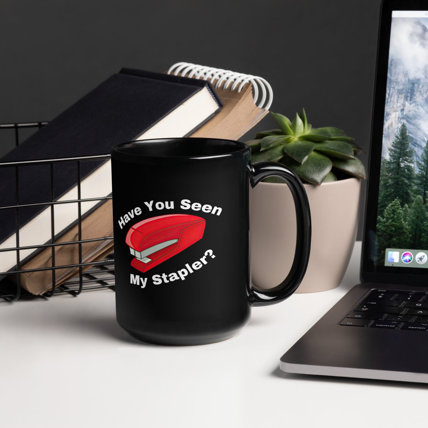 Black 15oz retro tech humor coffee mug with a stapler image and slogan ‘Have you seen my stapler?’ with handle on right.