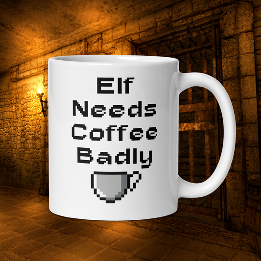 White 11oz retro coffee mug featuring an ‘Elf Needs Coffee Badly’ video game design with handle on the left in dungeon.