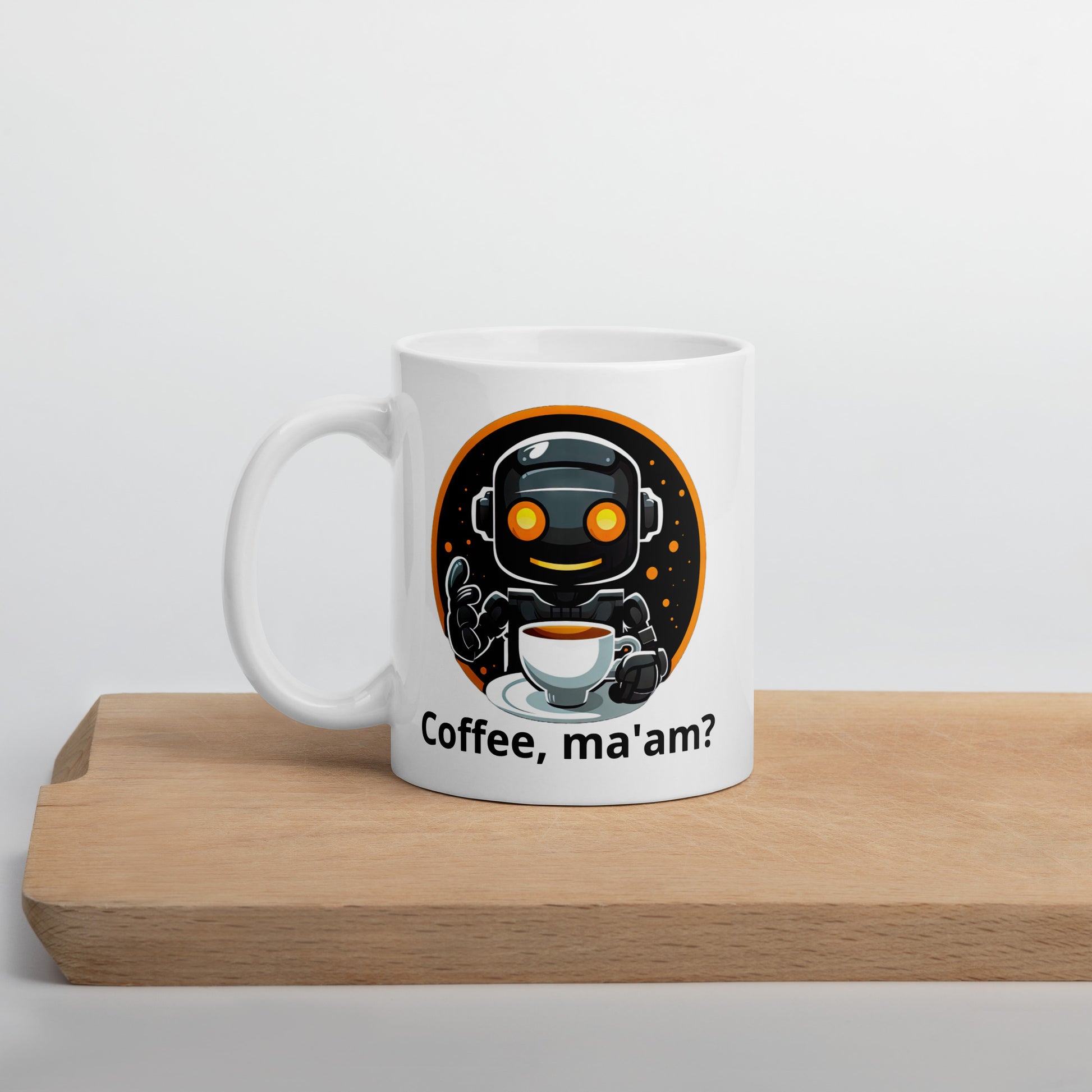 White 11oz robot themed coffee mug featuring a robot barista design with the slogan “Coffee, ma’am?” on cutting board.