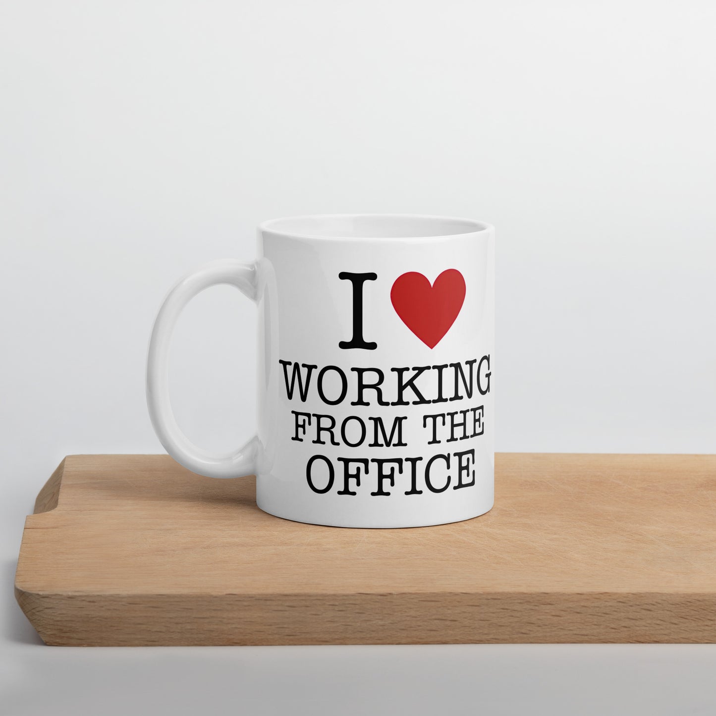 White 11oz tech humor coffee mug with an I Love NY style design that reads ‘I Love Working From the Office’ handle on left.