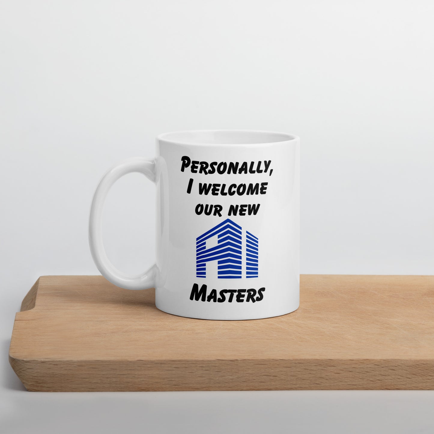 White 11oz tech humor coffee mug with the slogan ‘Personally, I Welcome Our New AI Masters’ with handle on the left.