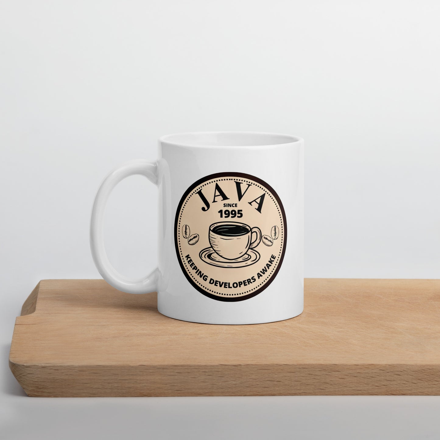 White 11oz tech humor coffee mug with an antique coffee shop logo that reads ‘Java: Keeping Developers Awake Since 1995’.