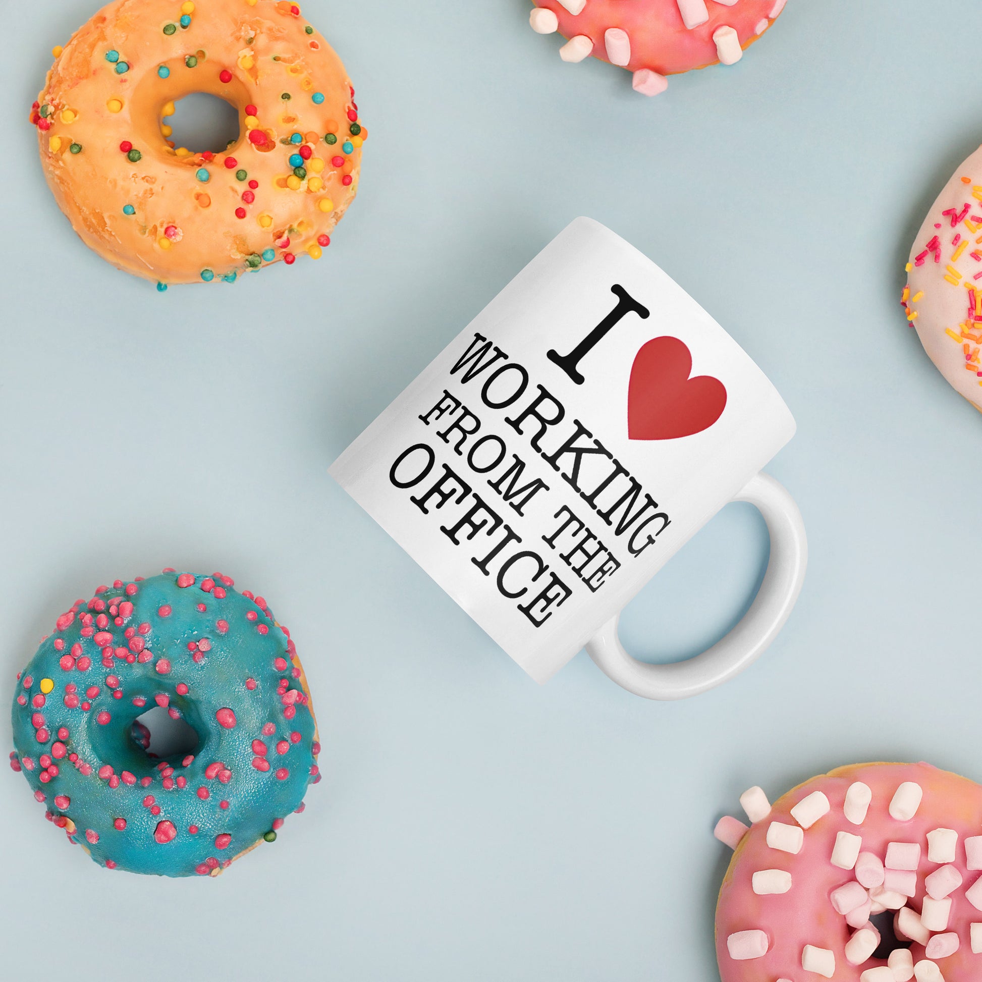 White 11oz tech humor coffee mug with an I Love NY style design that reads ‘I Love Working From the Office’ handle on right.