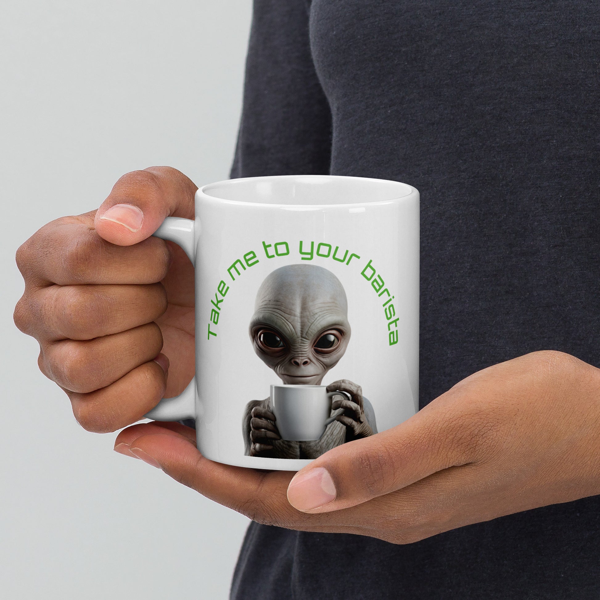 White 11oz sci-fi coffee mug with an alien holding a coffee cup and the slogan ‘Take me to your barista’ handle on the left.