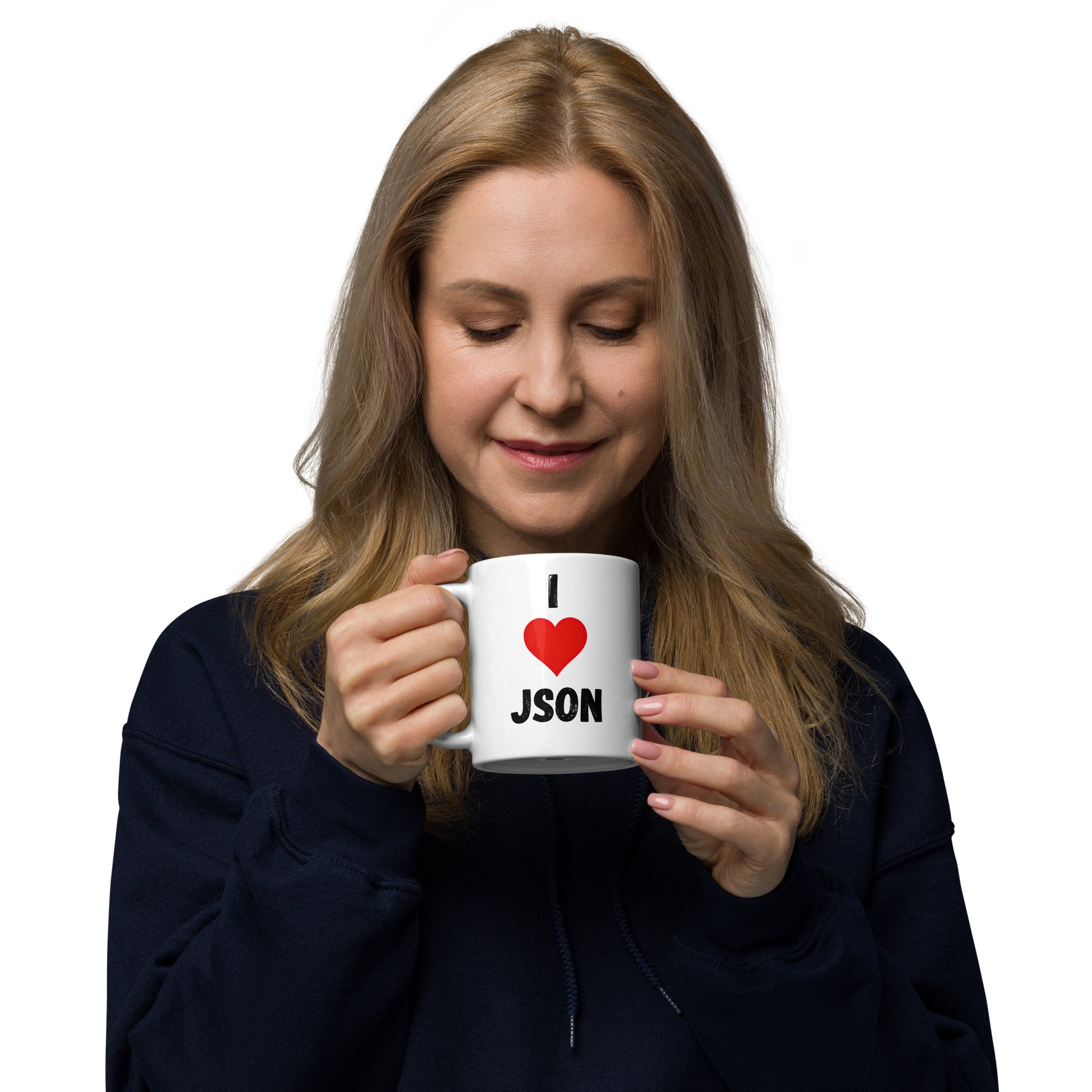 White 11oz tech humor coffee mug with a design slogan ‘I Love JSON’ with handle on left held by a woman.