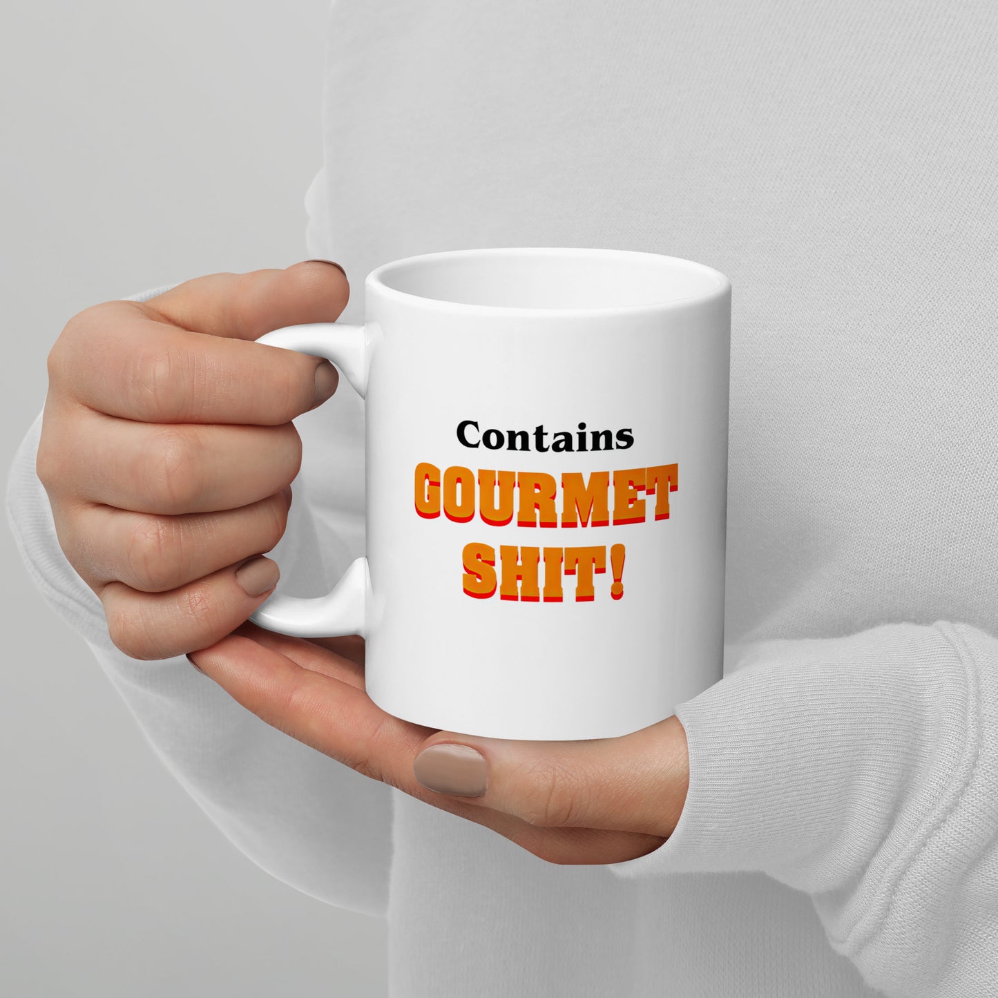 White 11oz retro humor coffee mug featuring slogan “Contains Gourmet Shit!” with handle on the left.