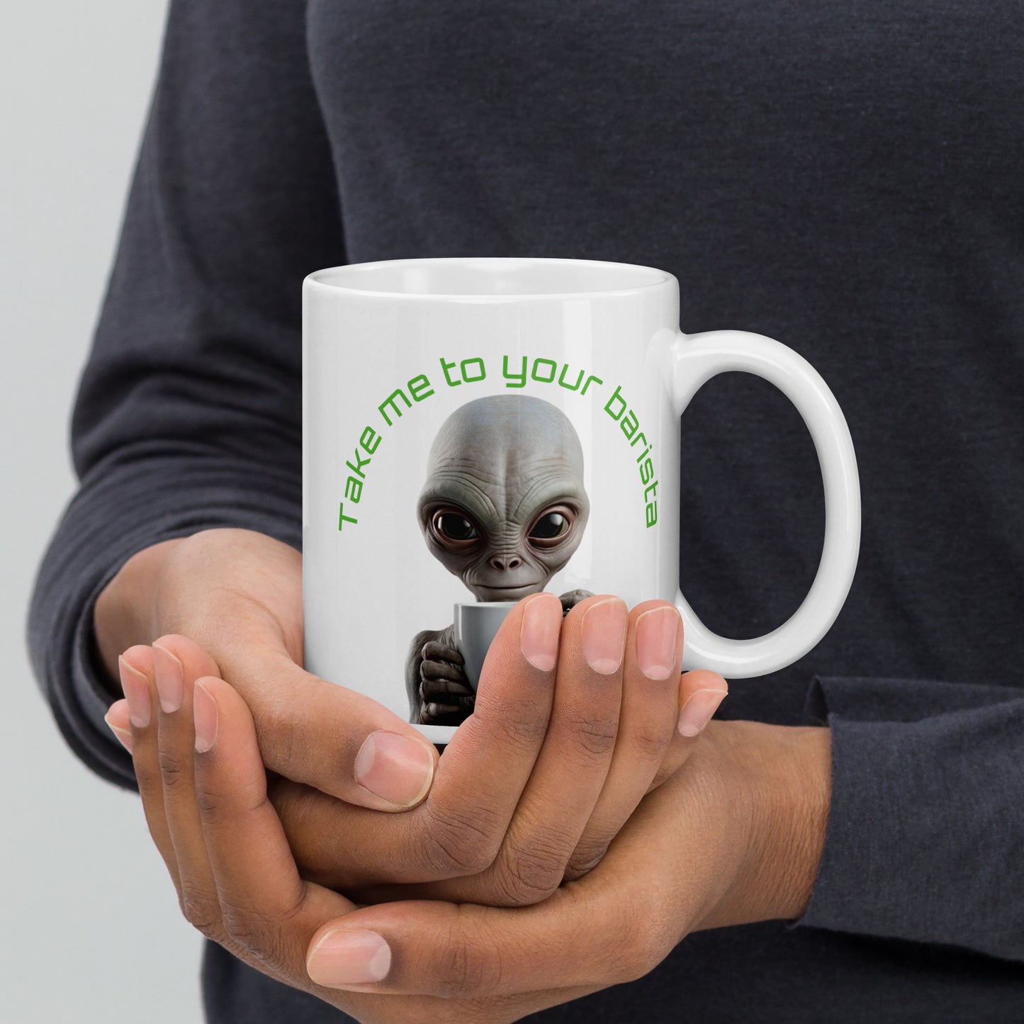 White 11oz sci-fi coffee mug with an alien holding a coffee cup and the slogan ‘Take me to your barista’ handle on the right.