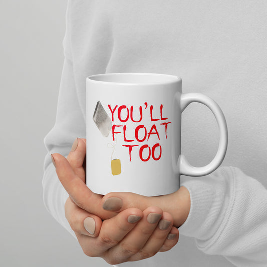 White 11oz horror themed coffee mug with a tea bag floating like a balloon that says, ‘You'll Float Too’ in the style of IT.