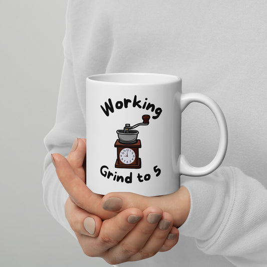 White 11oz tech humor coffee mug with a coffee grinder with a clock face and slogan that says, ‘Working Grind to 5’.