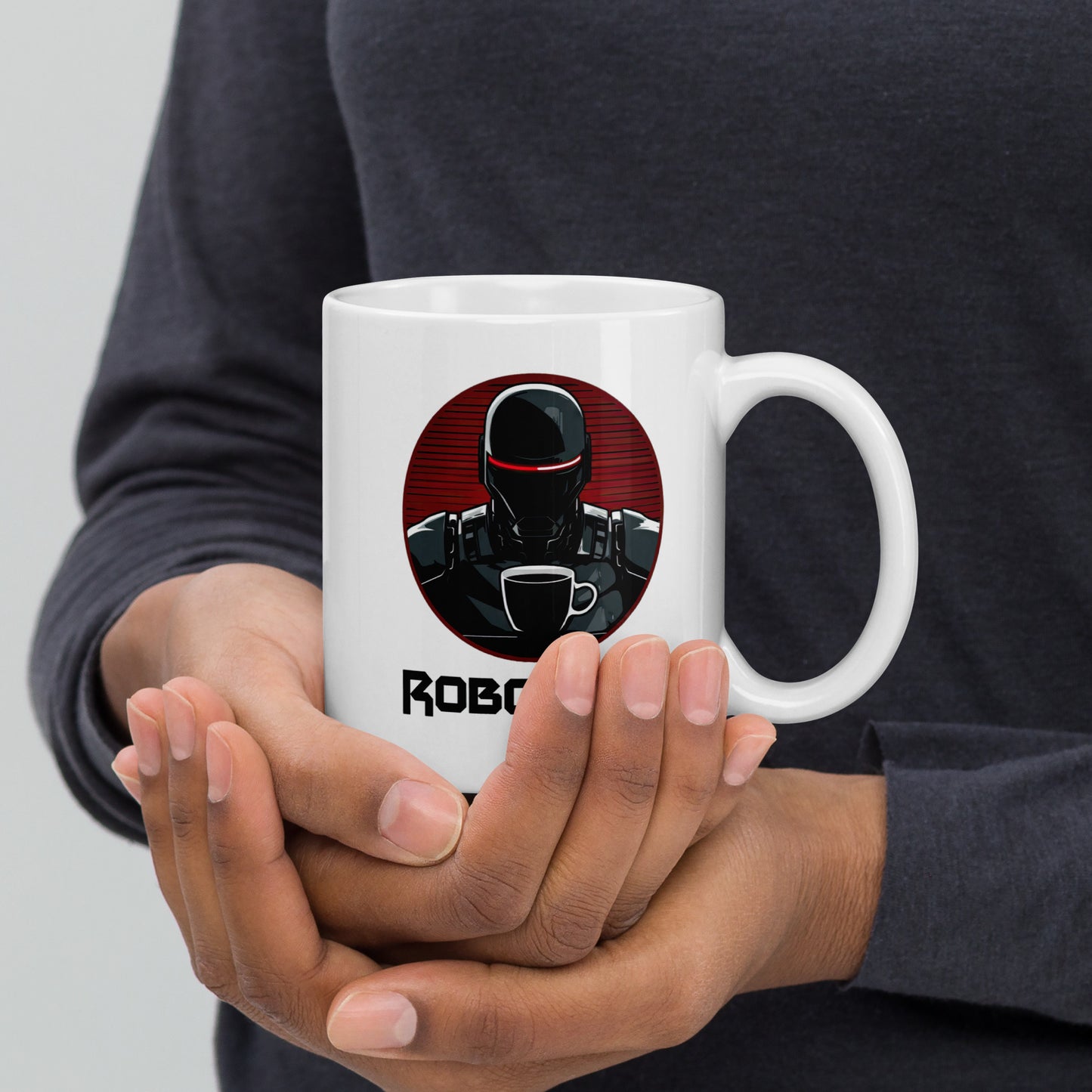 White 11oz coffee mug with the company logo of RoboCups on it. A robot with coffee mug and the word ‘RoboCups’ underneath.