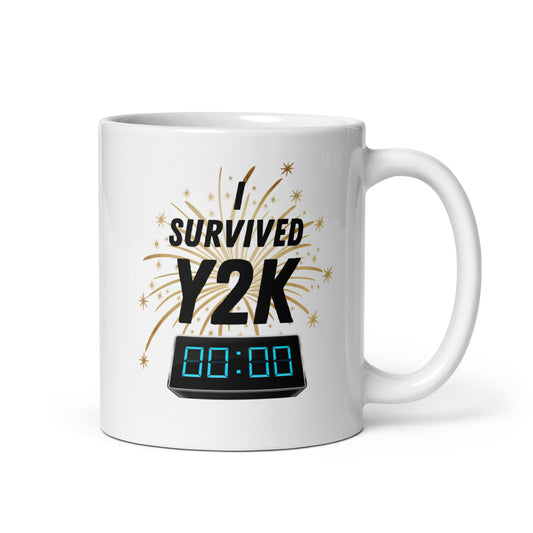 White 11oz tech humor coffee mug with a design of fireworks and a digital clock at midnight that reads ‘I Survived Y2K’