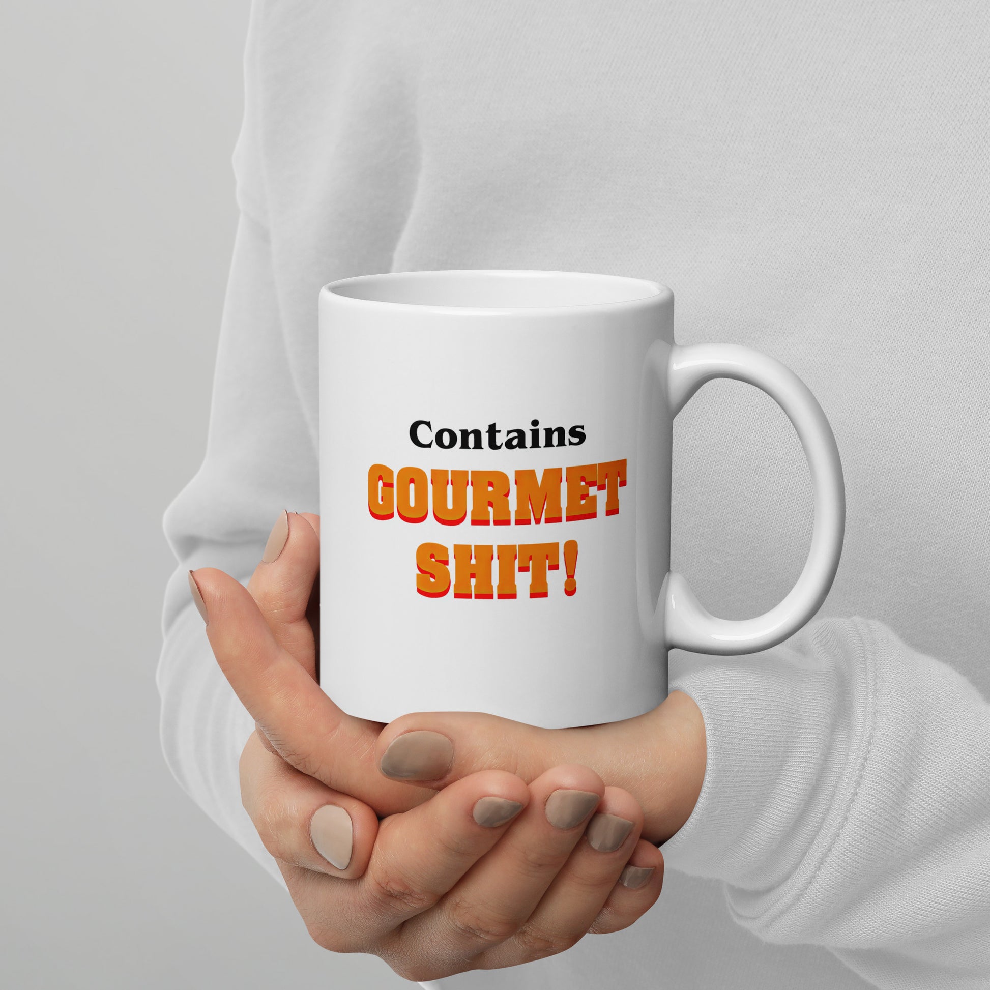 White 11oz retro humor coffee mug featuring slogan “Contains Gourmet Shit!” with handle on the right.