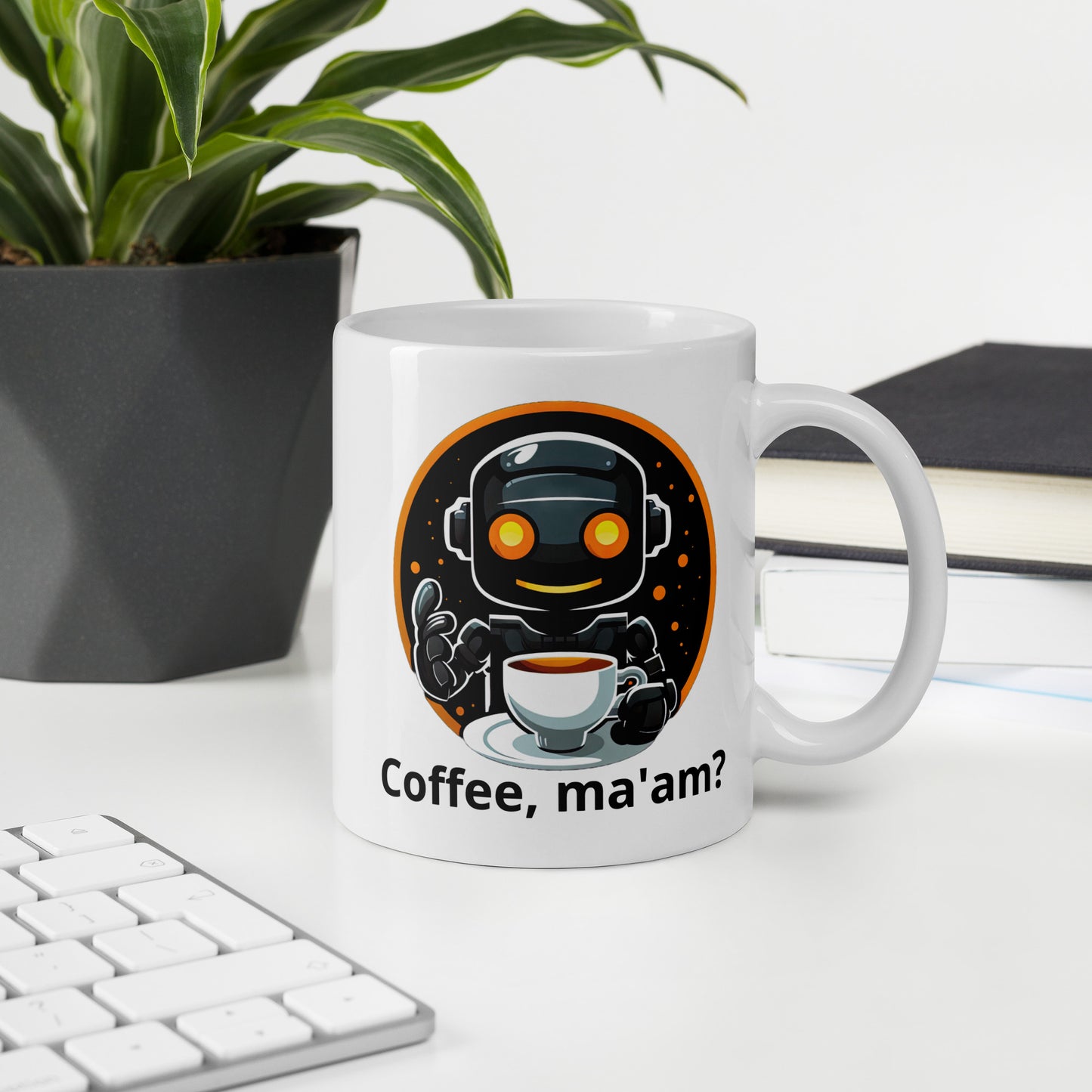 White 11oz robot themed coffee mug featuring a robot barista design with the slogan “Coffee, ma’am?” on office desk.