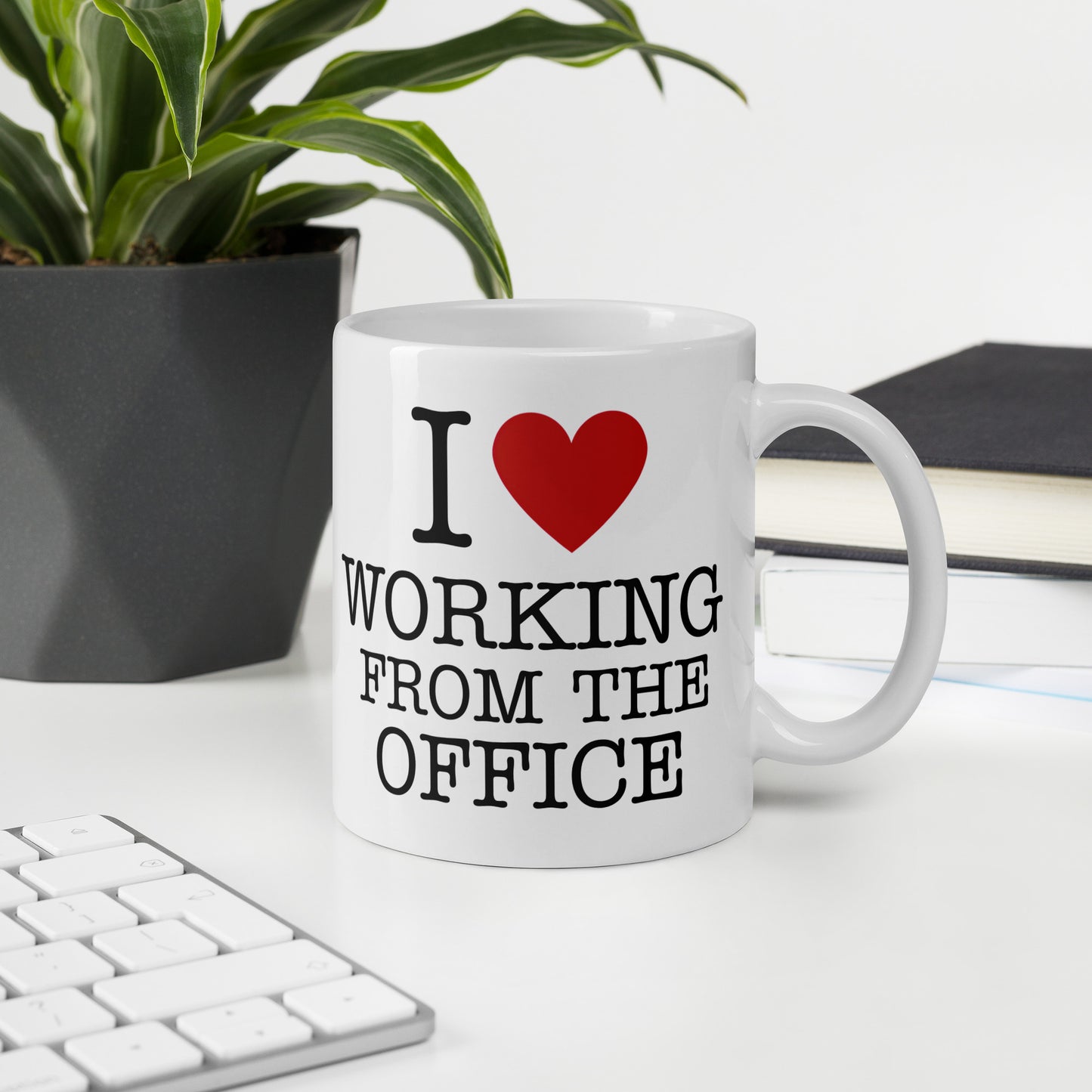 White 11oz tech humor coffee mug with an I Love NY style design that reads ‘I Love Working From the Office’ handle on right.