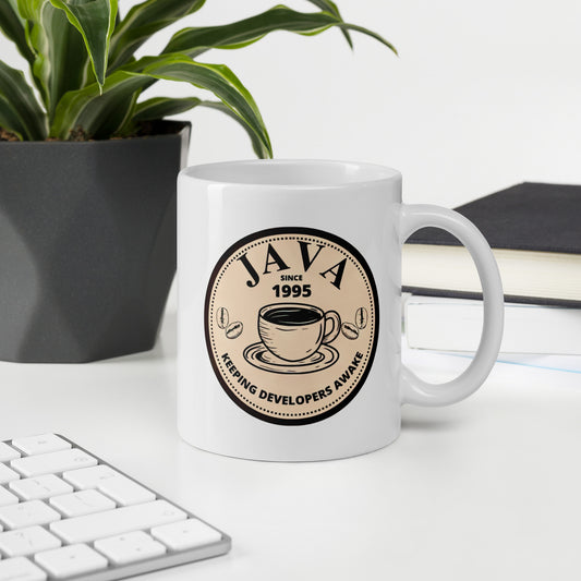 White 11oz tech humor coffee mug with an antique coffee shop logo that reads ‘Java: Keeping Developers Awake Since 1995’.