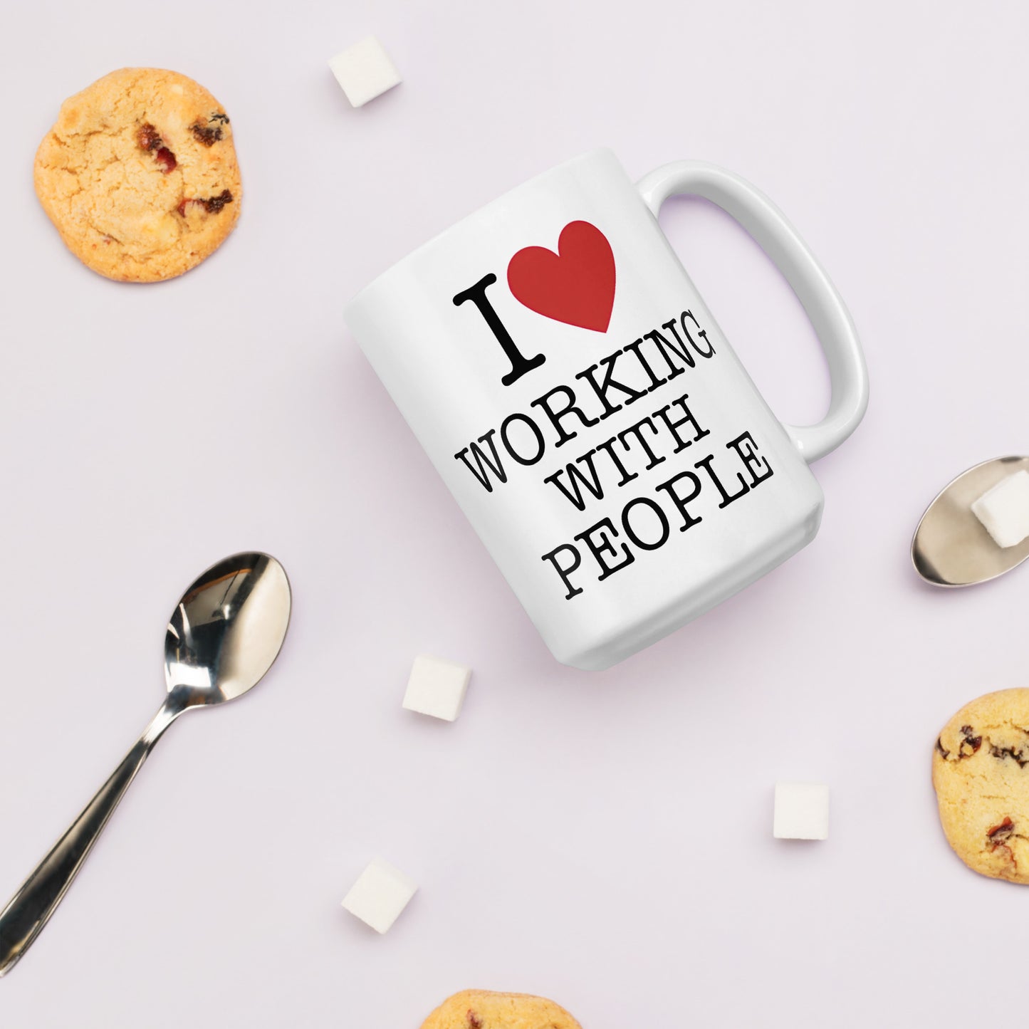 White 15oz tech humor coffee mug with an I Love NY style design that reads ‘I Love Working With People’ with handle on right