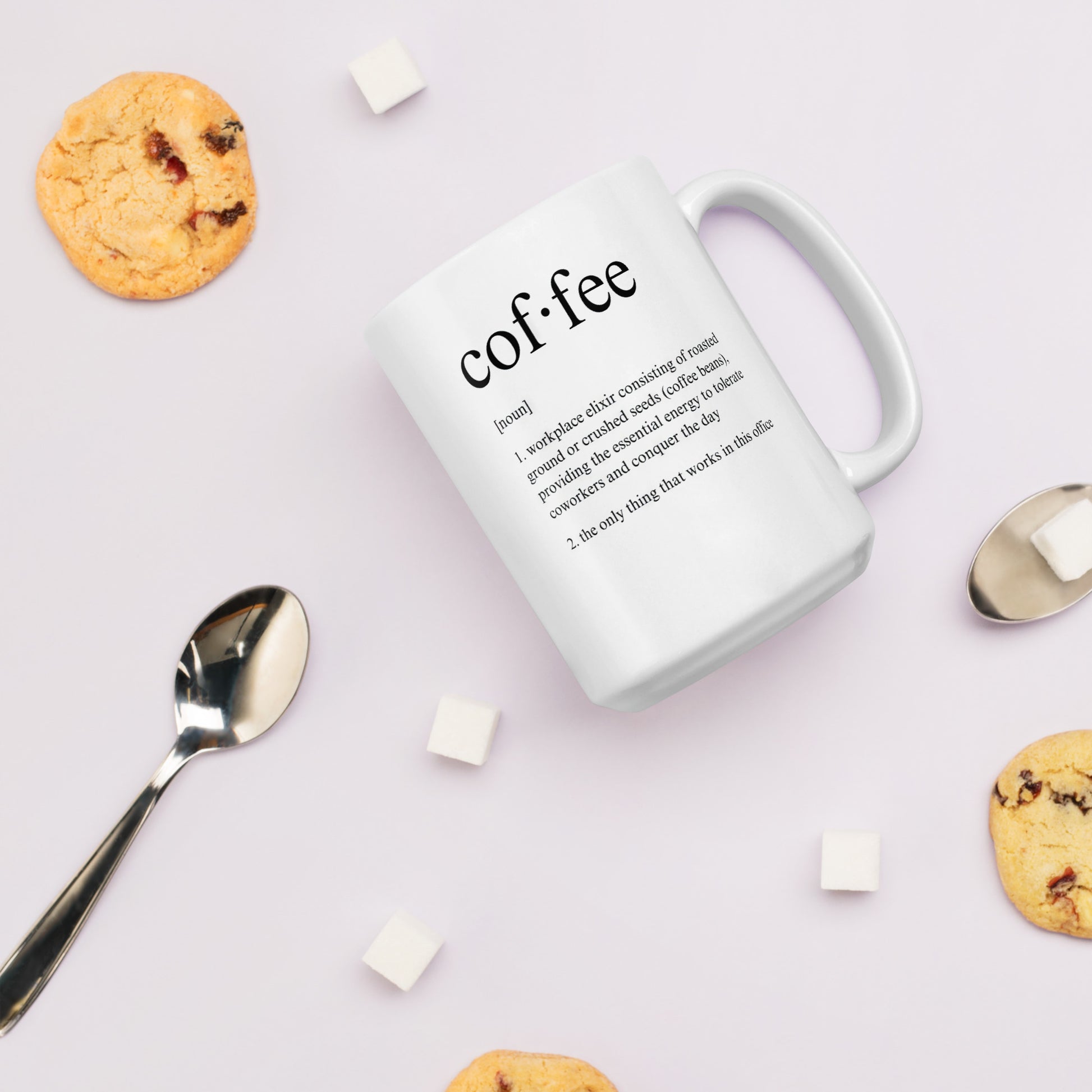 White 11oz tech humor coffee mug featuring a ‘Dictionary Definition Coffee & Coworkers’ design surrounded by biscuits and coffee spoons.