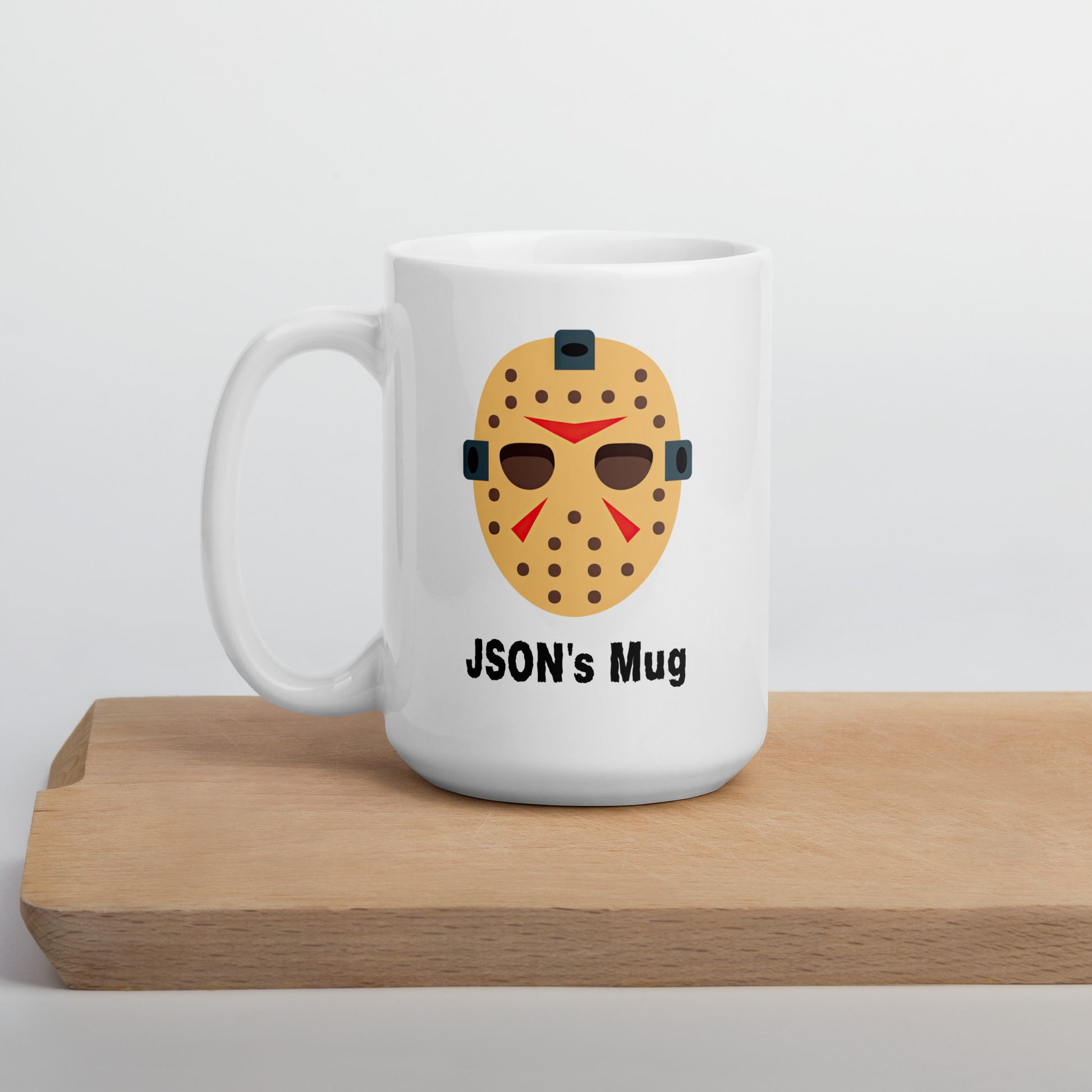 White 15oz tech humor horror coffee mug with a hockey mask design that reads ‘JSON's Mug’ handle on the left.