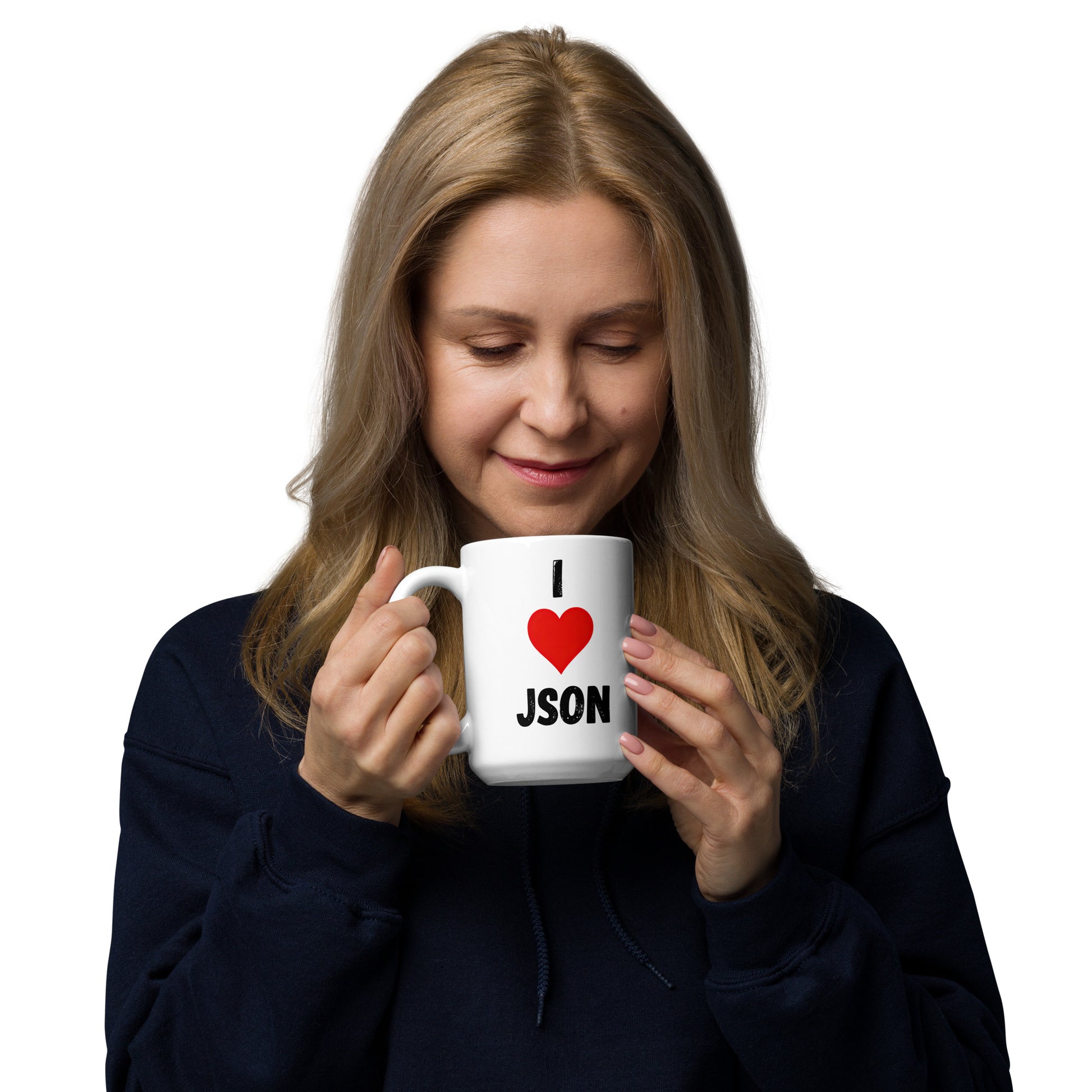 White 15oz tech humor coffee mug with a design slogan ‘I Love JSON’ with handle on left held by a woman.