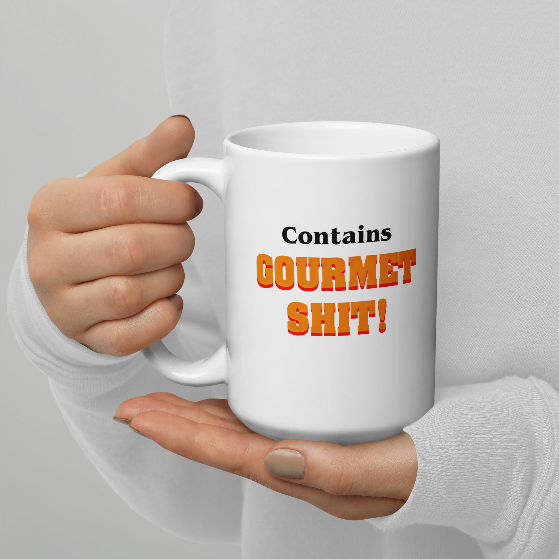 White 15oz retro humor coffee mug featuring slogan “Contains Gourmet Shit!” with handle on the left.