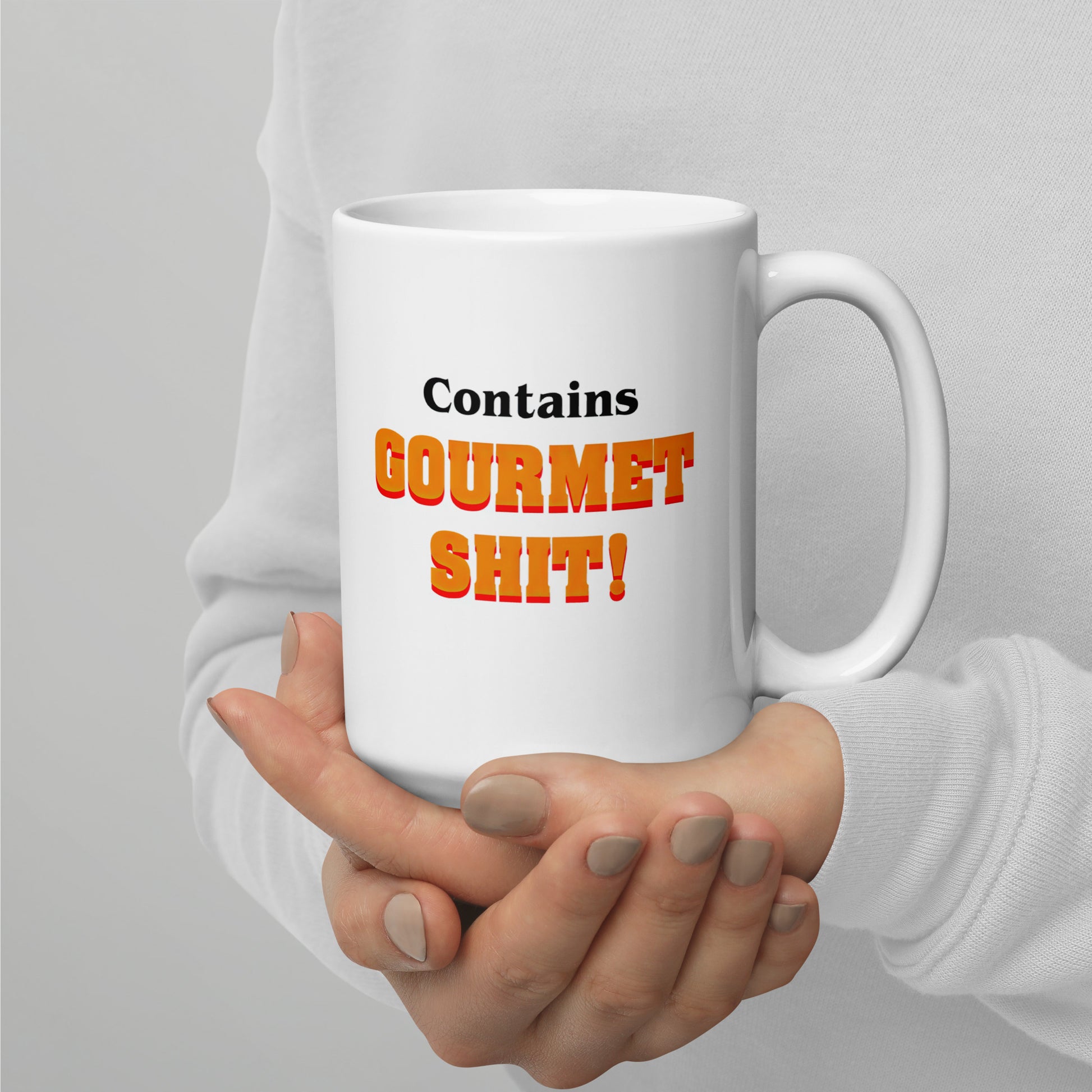 White 11oz retro humor coffee mug featuring slogan “Contains Gourmet Shit!” with handle on the right.