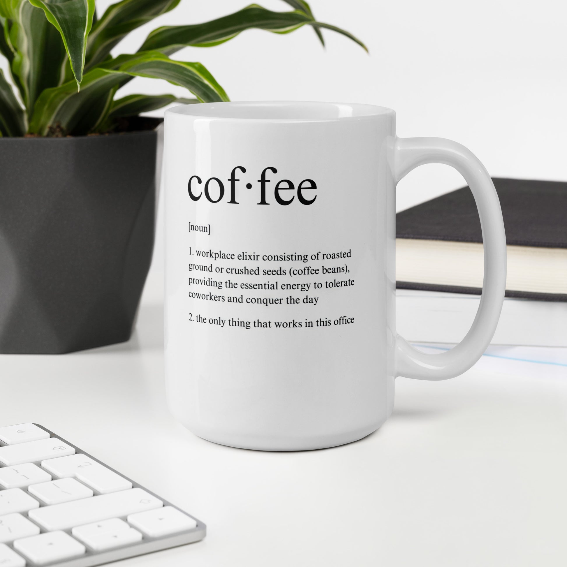 White 15oz tech humor coffee mug featuring a ‘Dictionary Definition Coffee & Coworkers’ design with handle on the right on desk.